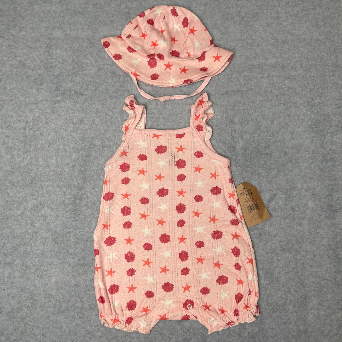 Pink Chick Pea baby romper and matching sun hat with seashell and starfish print